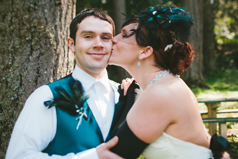 bride kissing groom on the cheek