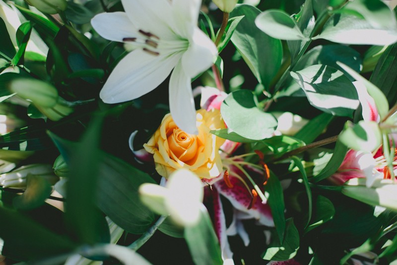 Floral arrangement with white Lilies, yellow Roses, and Stargazer Lilies. 