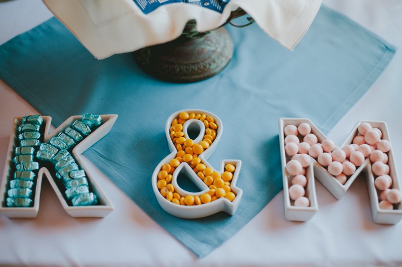 Monogram and ampersand candy dishes with a variety of candies. 