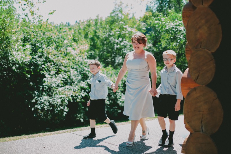 Bride's two young sons walk her down the aisle. 