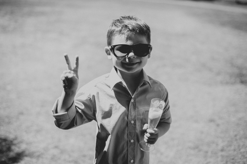 Bride's son holding up a peace sign. 