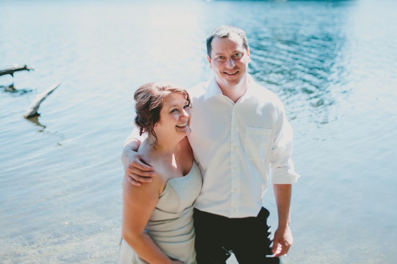 Bride and groom standing the water at Island Lake Park in Silverdale. 