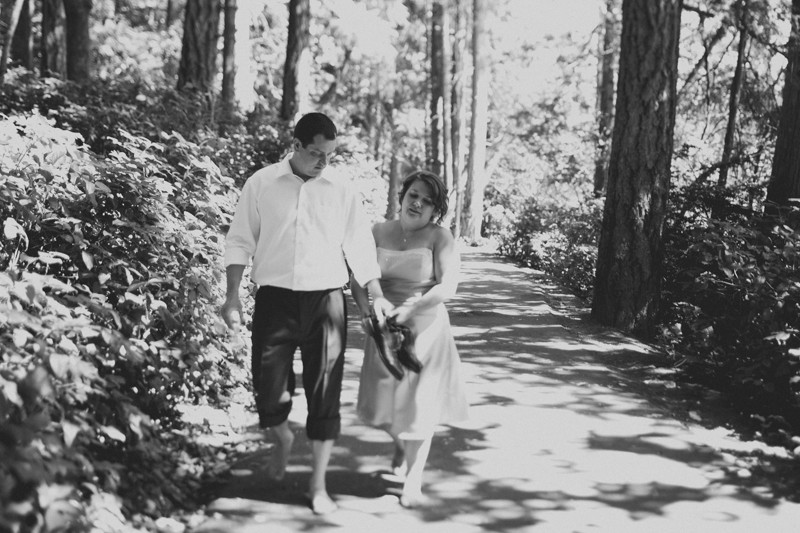 Bride and groom walking together at Island Lake Park in Silverdale. 