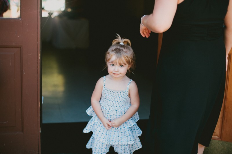 Little girl with ruffled summer dress at wedding. 