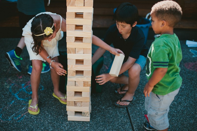 Children playing a game of Giant Jenga at a wedding. 