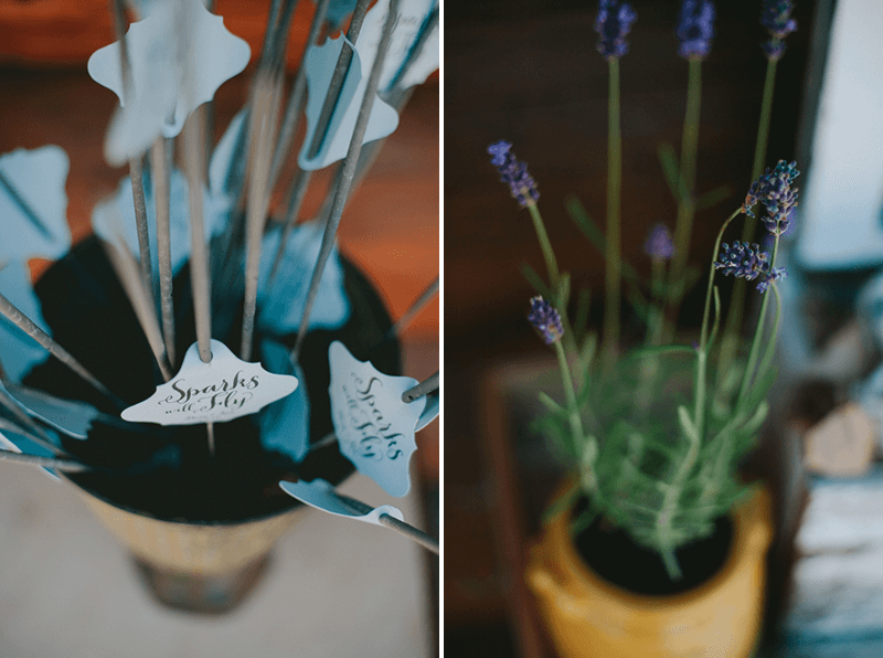 Wedding send-off sparklers with paper tags that say "Sparks will Fly", and a potted Lavender plant. 