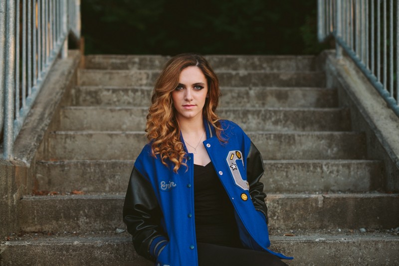 Olympic High School senior girl wearing a blue and black letterman jacket, by Meghann Prouse, Indie Photographer. 
