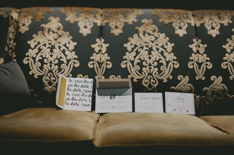 Luxury damask print couch with modern wedding invitation suite. 