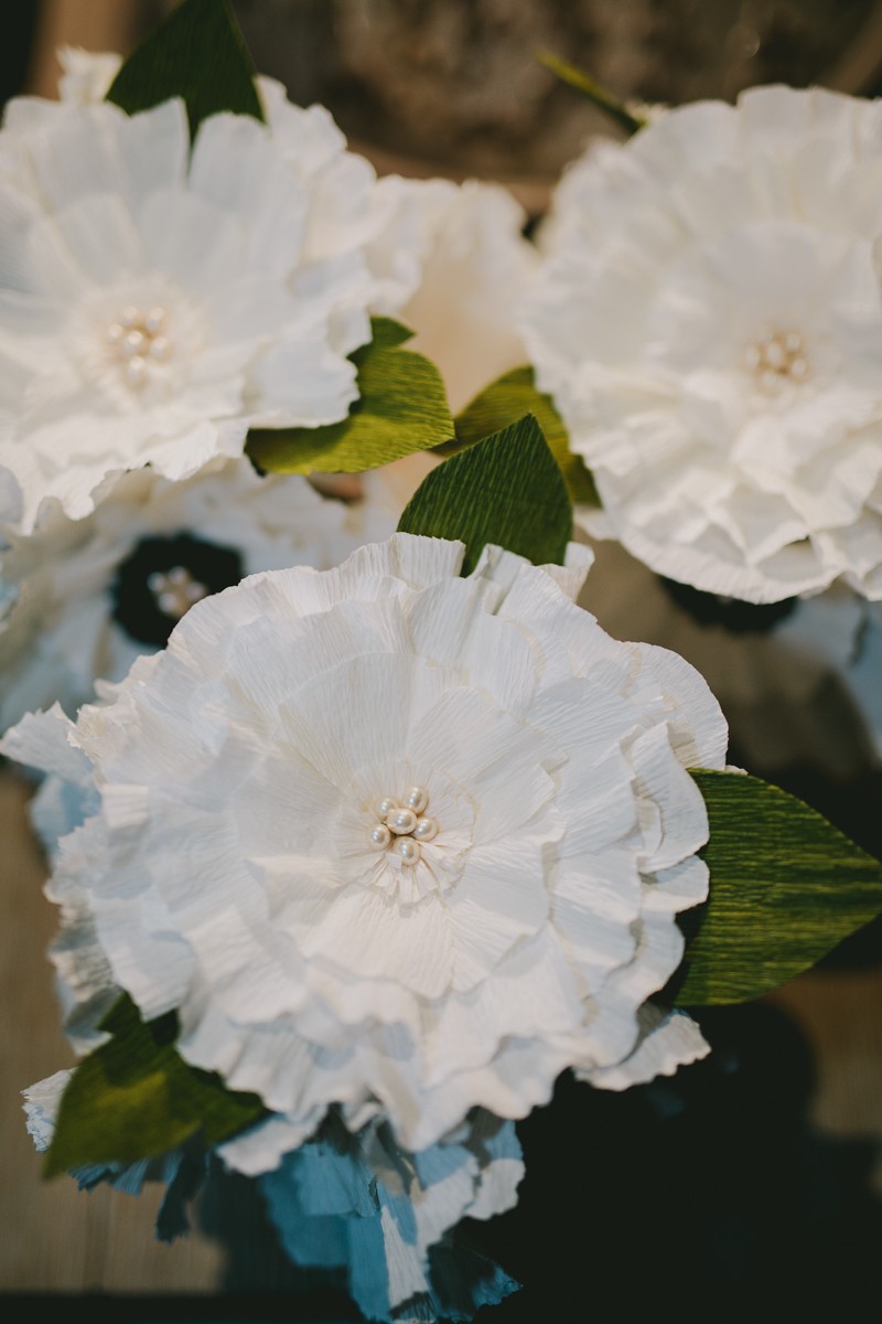 Handcrafted paper flower bouquets with ruffled leaves and pearl beads in the center. 