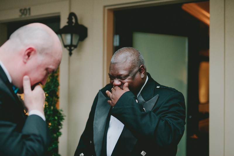 Emotional first look with two grooms at Ballard Hotel. 