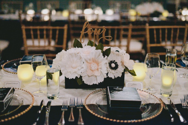 Elegant wedding with gold laser cut table number and handmade paper flower centerpiece. 