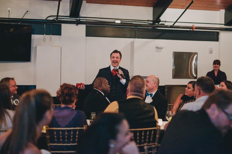 Groomsman giving speech at wedding reception. 