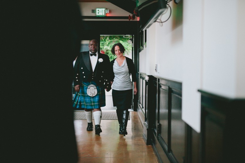 Close friend walks groom down the aisle at Olympic Rooftop Pavilion. 