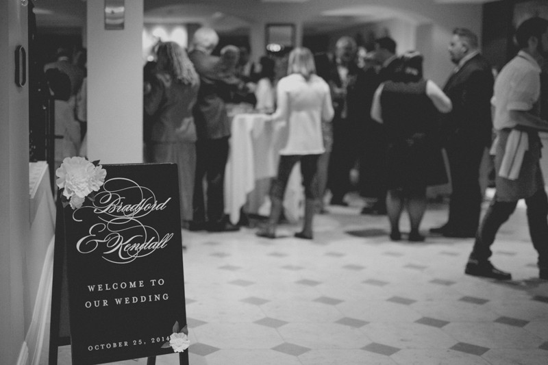 Wedding cocktail hour at Hotel Ballard, with elegant sandwich board welcome sign. 