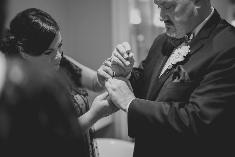 Groom getting ready, with his sister attaching cufflinks at Hotel Ballard. 