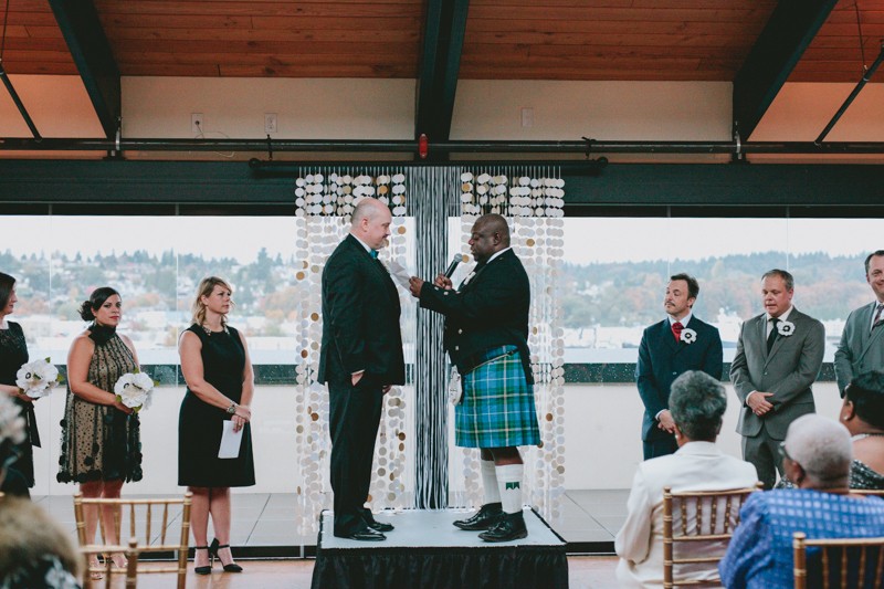 Same sex wedding with grooms on an altar platform. 