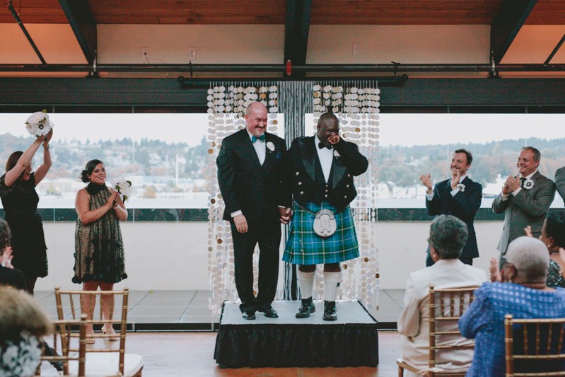 Two grooms face their loved ones with excitement, at Olympic Rooftop Pavilion. 