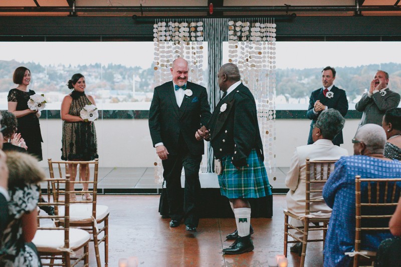 Same sex wedding with two grooms in a suit and a kilt. 