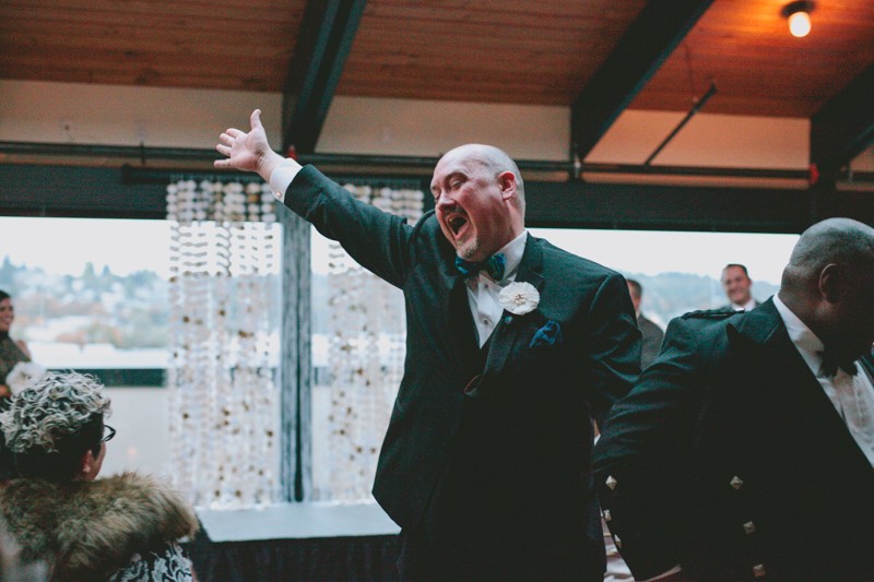 Excited groom waves to the guests while exiting ceremony.