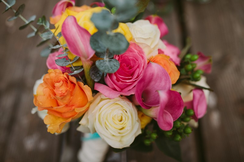 Vibrant bridal bouquet with Roses, Calla Lilies, and Eucalyptus leaves. 