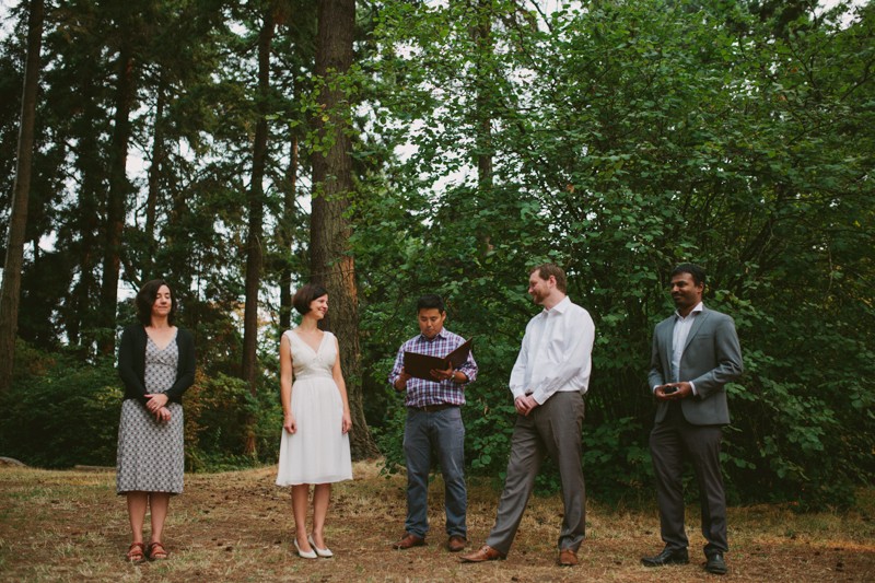 Simple outdoor wedding ceremony, with bride in a tea-length v-neck wedding dress, at Lincoln Park in West Seattle. 