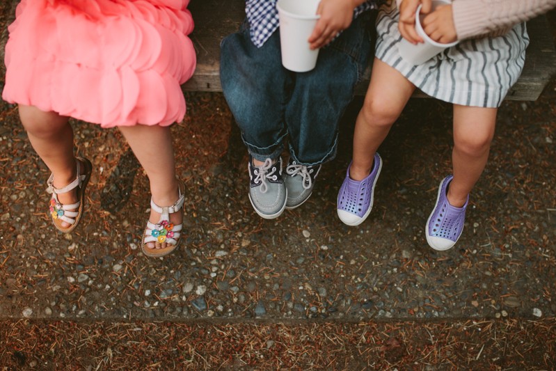 Toddlers sitting together at a wedding. 