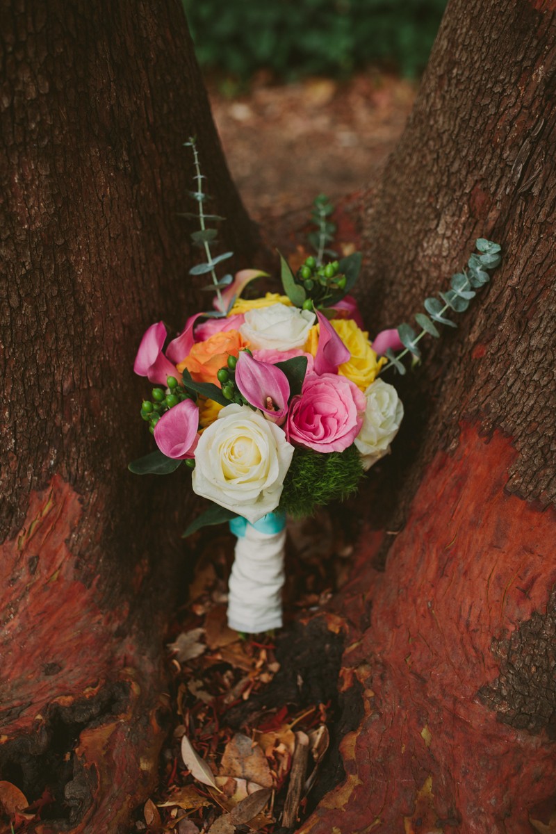 Vibrant pink, yellow and white bridal bouquet with Roses, Calla Lilies, and Eucalyptus. 