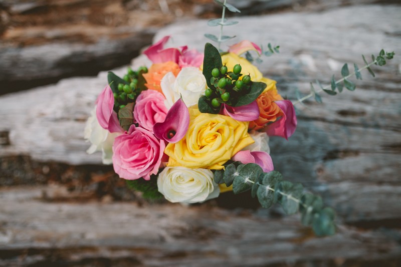 Colorful bridal bouquet with Roses, Calla Lilies, and Eucalyptus leaves. 