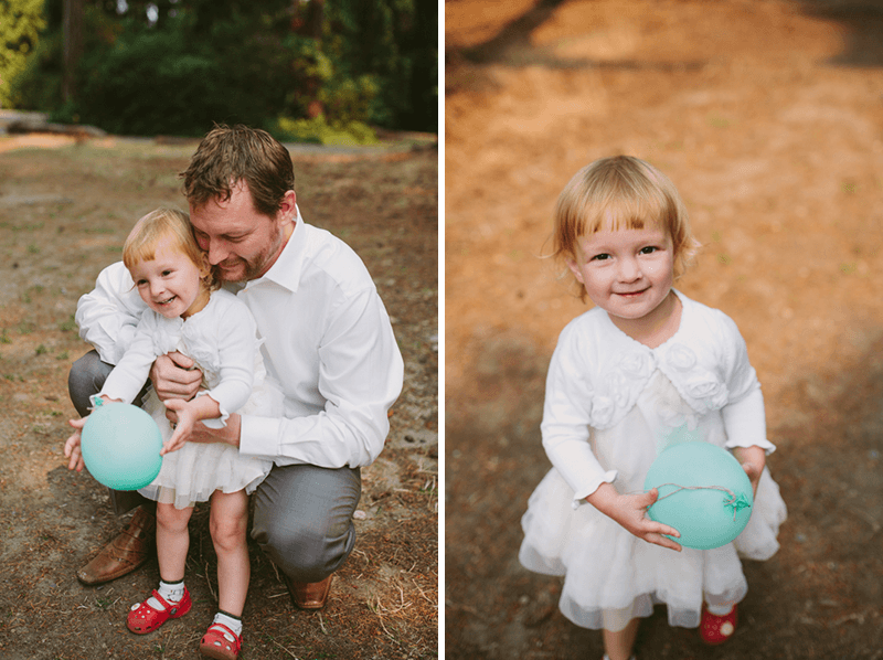 Bride and groom's daughter, in a pretty white dress and sweater. 