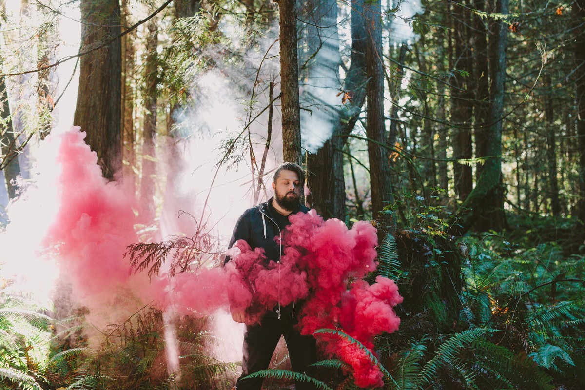 The Dear Hunter frontman, Casey Crescenzo, in the forest with smoke grenades, photographed for Kerrang! | PNW band photographer Meghann Prouse | www.photomegs.com