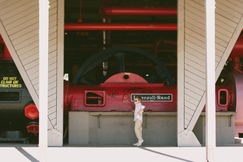 Little boy wearing sunglasses at Gas Works Park in Seattle, for a summer wedding. 