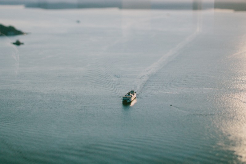 Bremerton elopement with ferry navigating Puget Sound. 