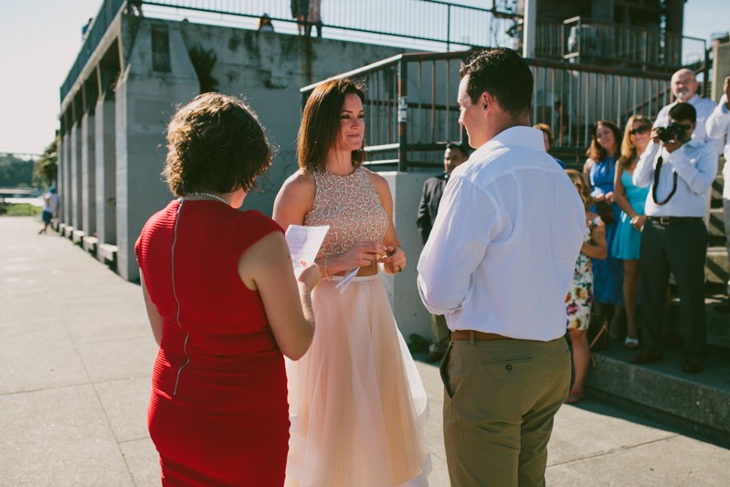 Modern bride wearing a two-piece dress, with a beaded, sleeveless top, and sheer a-line skirt. 