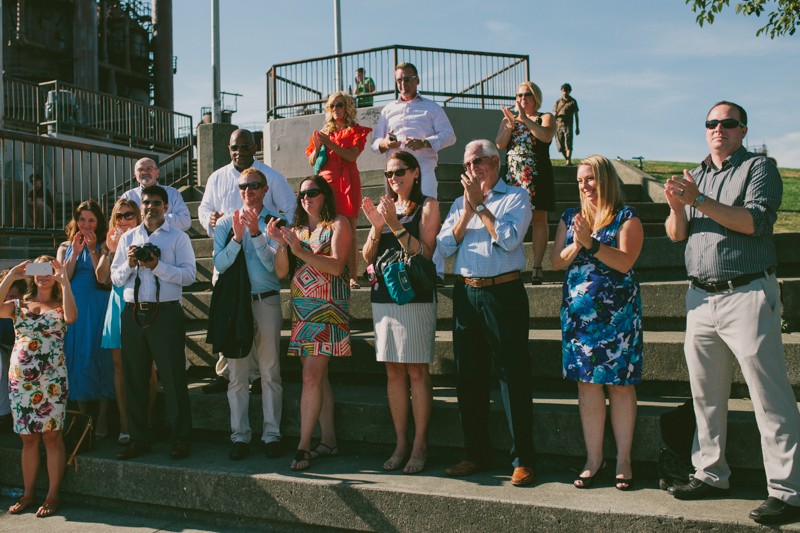 Guests applaud bride and groom, at Gas Works Park in Seattle, WA. 