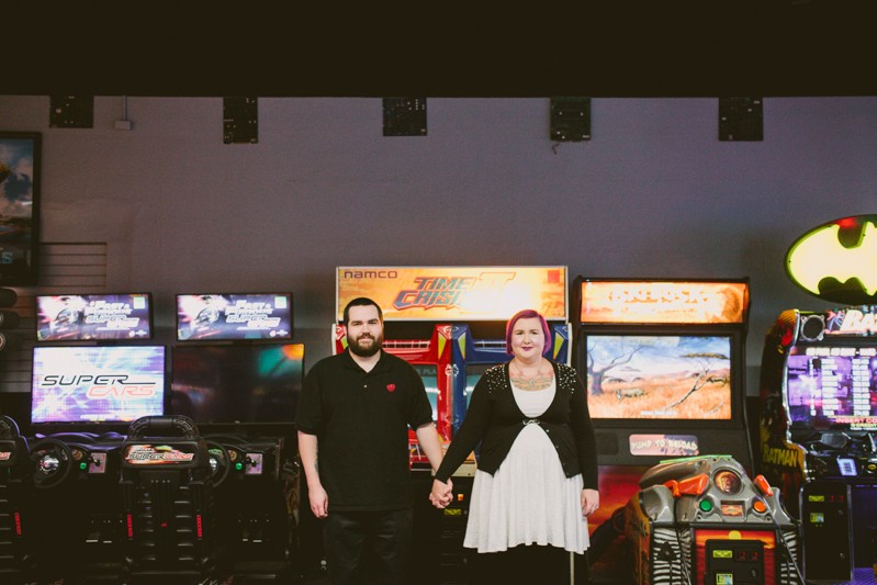 Modern arcade engagement session in downtown Bremerton, Washington, with bride and groom holding hands. 