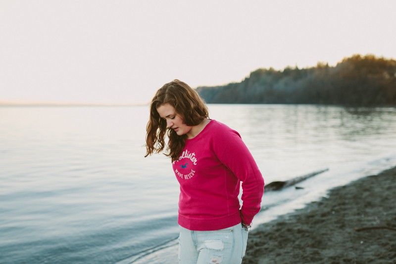 Waterfront portraits of Olympic High School senior girl, wearing a pink shirt and jeans. 