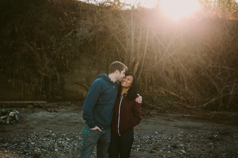 Happy couple in comfy, colorful sweatshirts, on the beach in Kitsap County, WA. 