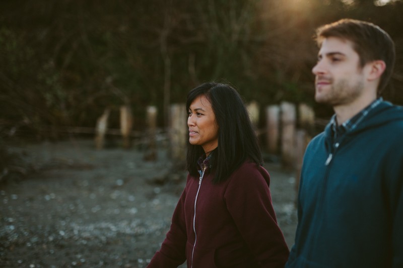 Indie portrait session, with young couple wearing hoodie sweatshirts, on the beach in Bremerton, WA. 