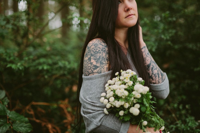 Whimsical forest portraits, with girl holding a bouquet of white Button Mums.