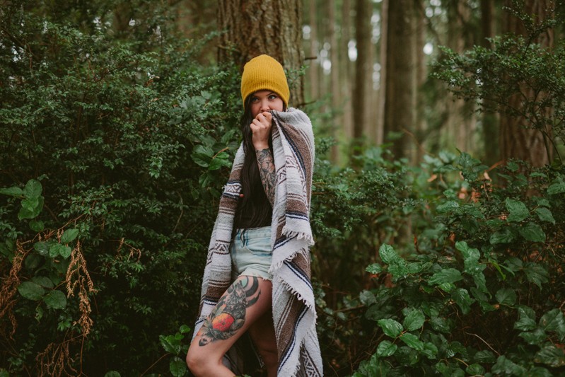 PNW portraits in the woods, with model covered in a southwestern blanket. 