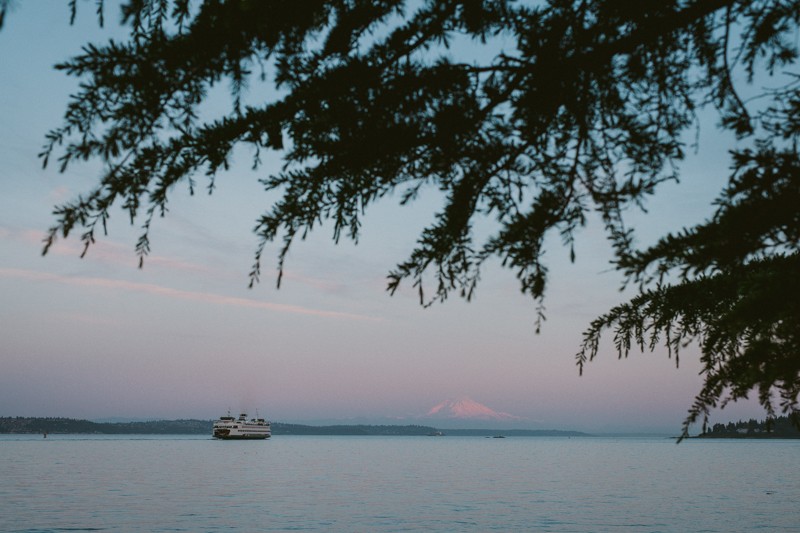 Picturesque sunset from Bainbridge Island, WA, featuring a ferry boat and Mt. Rainier.