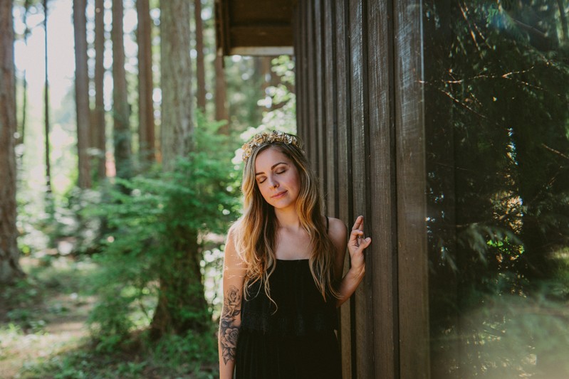Dreamy forest portrait session, with model wearing a golden flower crown headband. 