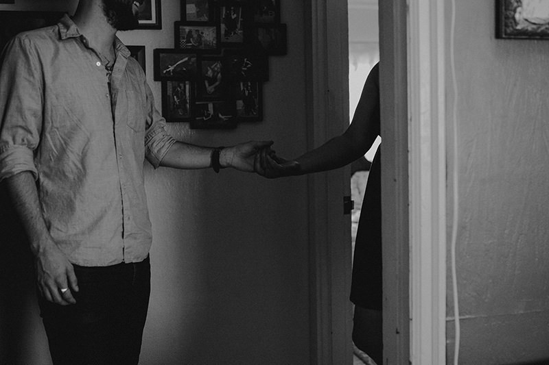 Edgy in home portrait session, with Bremerton, WA couple holding hands. 