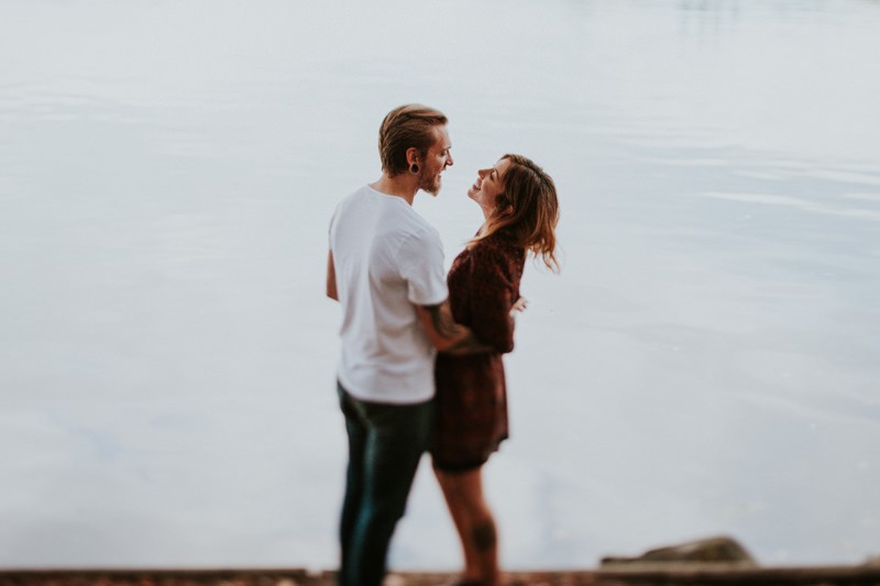 Bainbridge Island portrait session, with couple hugging on the waterfront. 
