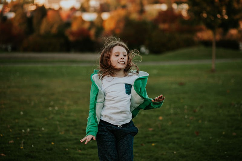 Simple lifestyle portraits, with long haired little boy jumping up and down. 