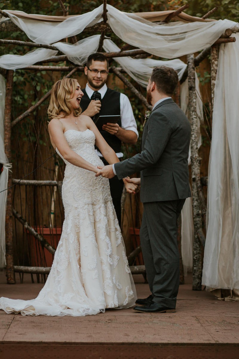 Garden wedding bride wearing a strapless beaded dress, with trumpet skirt. 