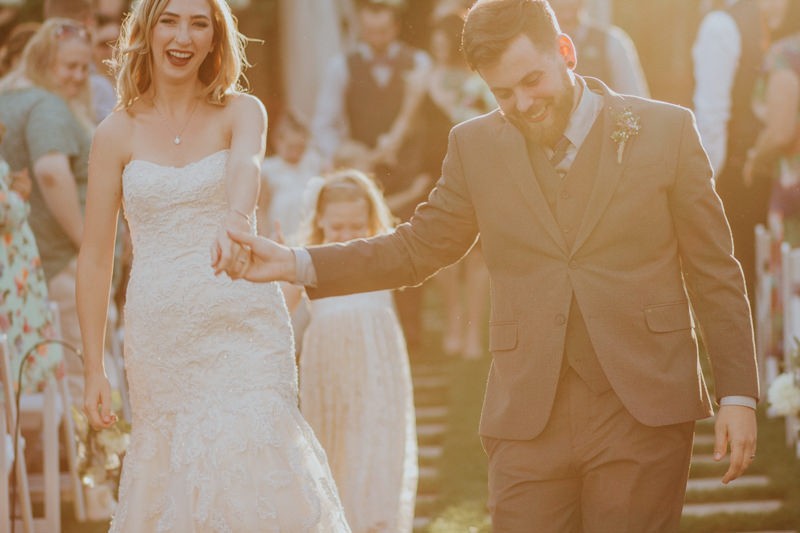 Bride and groom dancing down the aisle after their ceremony. 