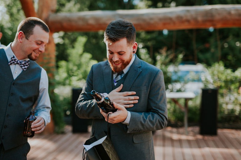 Groom opening a thoughtful gift from his bride. 