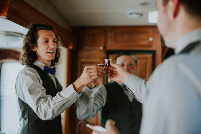 Groomsmen toasting with shots of liquor. 