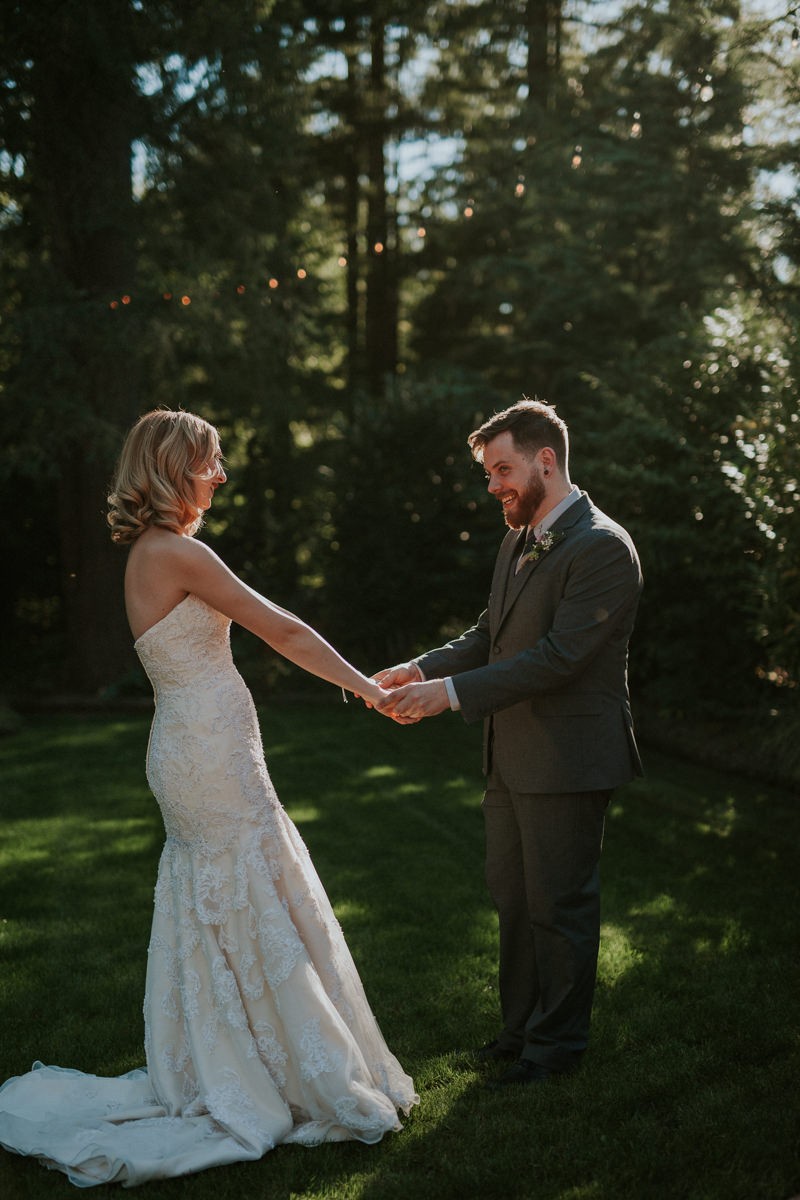 Modern garden bride and groom first look, with bride in a strapless trumpet dress. 